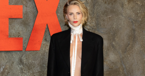 Charlize Theron a apărut fără sutien și bluză într-un costum Dior la premiera Apex