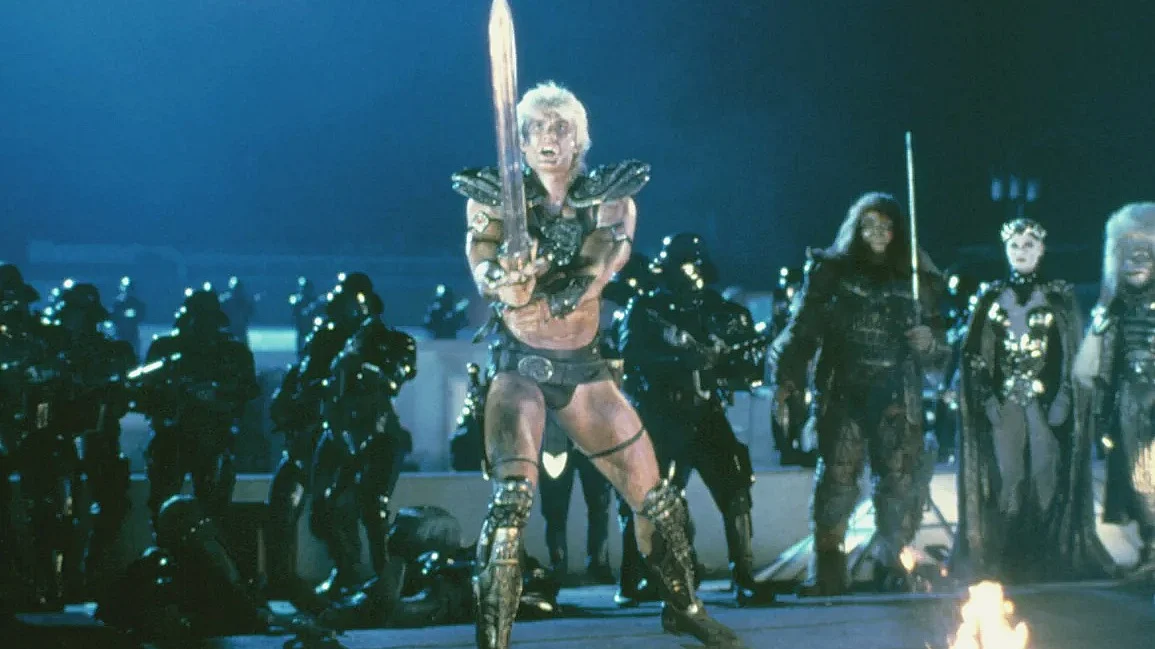 Dolph Lundgren, a former chemical engineer who gave up a Fulbright Scholarship to MIT to pursue acting, as He-Man in Masters of the Universe, which some critics compared unfavorably to Star Wars.